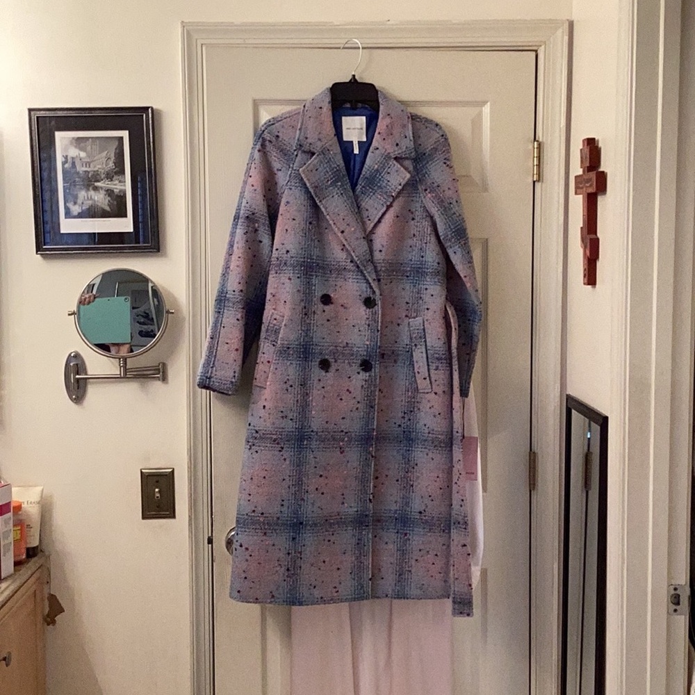 Double breasted wool blend coat with matching belt.